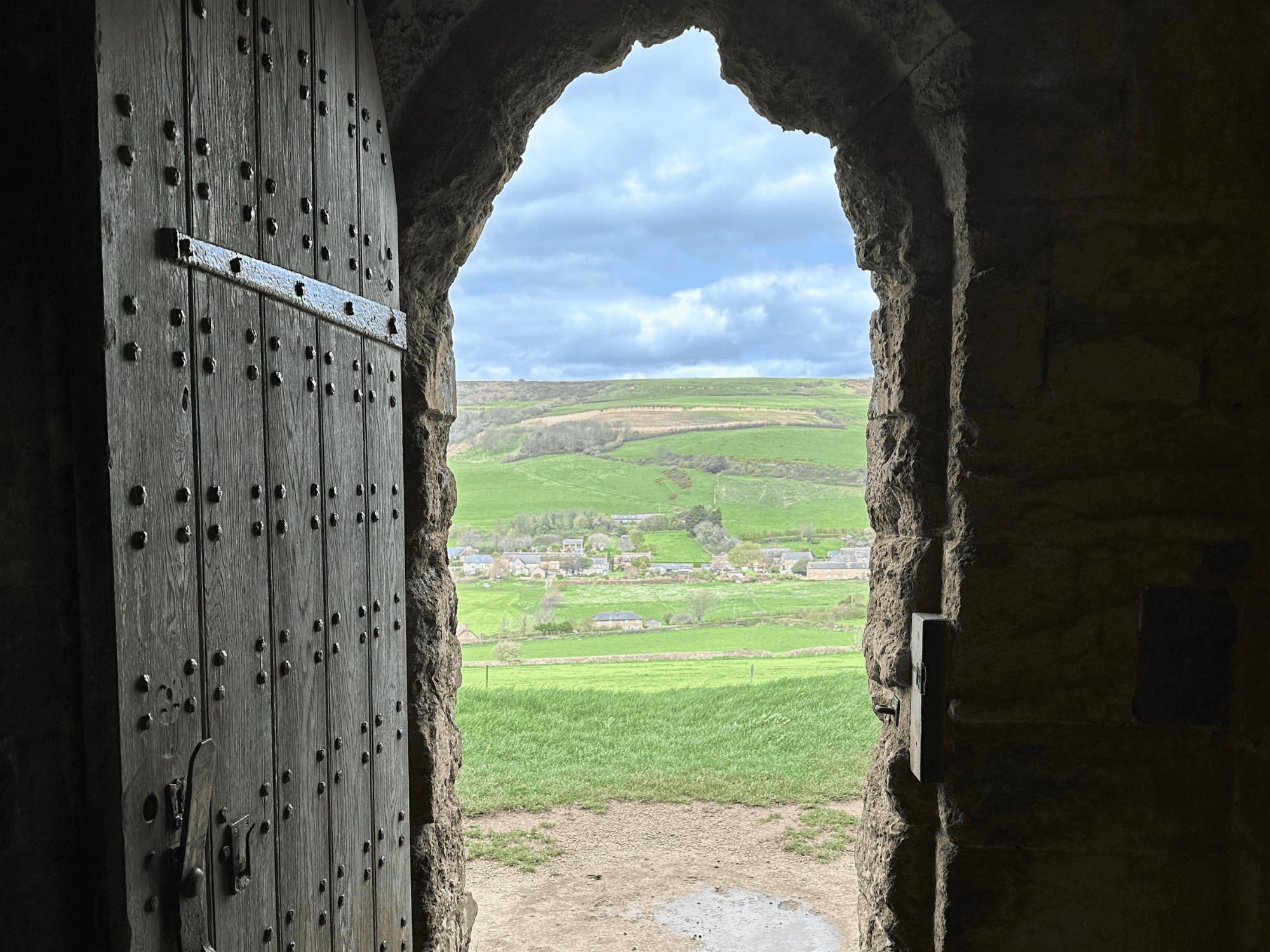 wooden and stone door with landscape behind